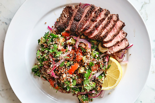 Sliced grilled steak with vegetables on plate