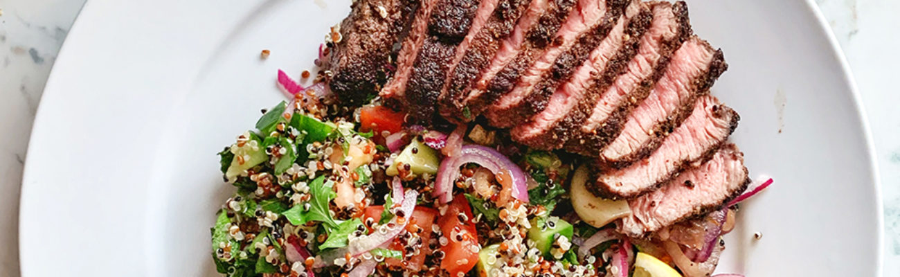 Sliced grilled steak with vegetables on plate