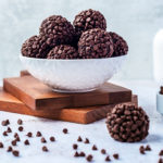 Chocolate Brownie Bites in a white bowl on wood cutting boards