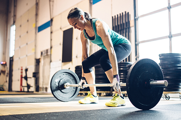 Older woman lifting weights in a gym