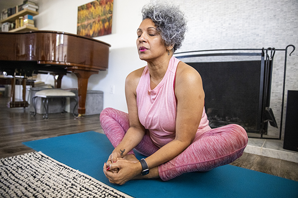 Older woman doing yoga at home