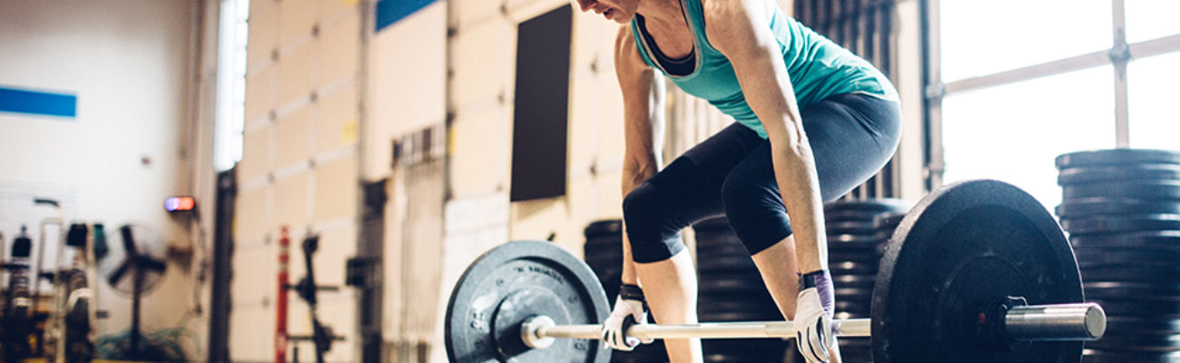 Older woman lifting weights in a gym