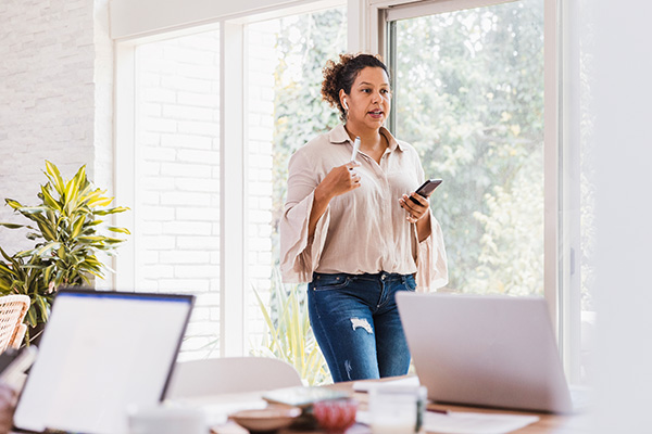 Woman WFH walking while talking on phone