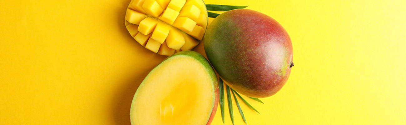 Ripe mango on colored background, top view