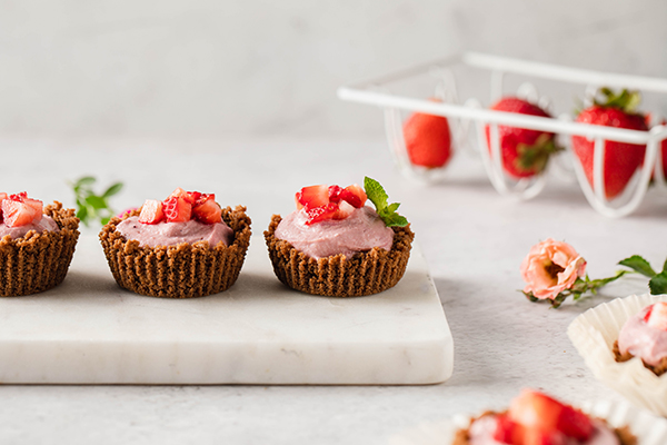 Mini Strawberry Cheesecakes on marble cutting board