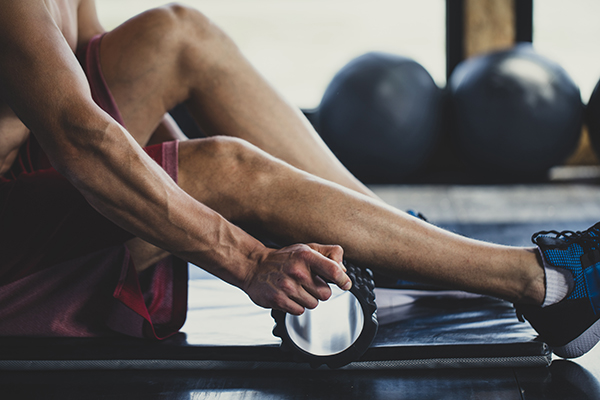 Man foam rolling his calf