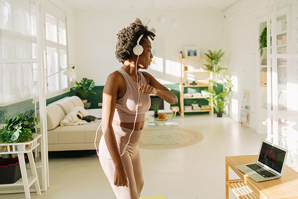 Woman doing online workout at home