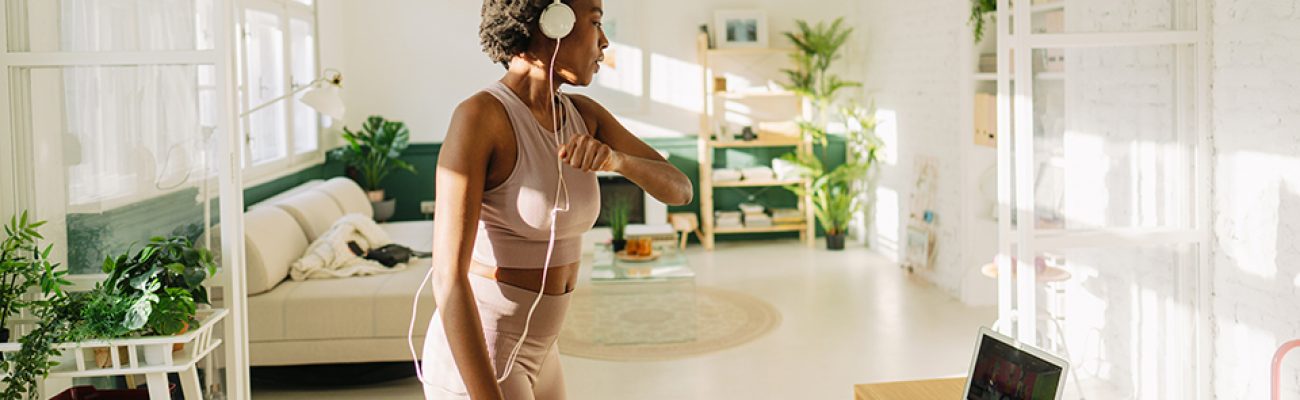 Woman doing online workout at home