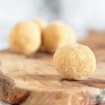 Eggnog Protein Balls on wooden cutting board