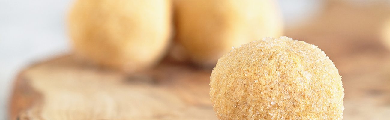 Eggnog Protein Balls on wooden cutting board