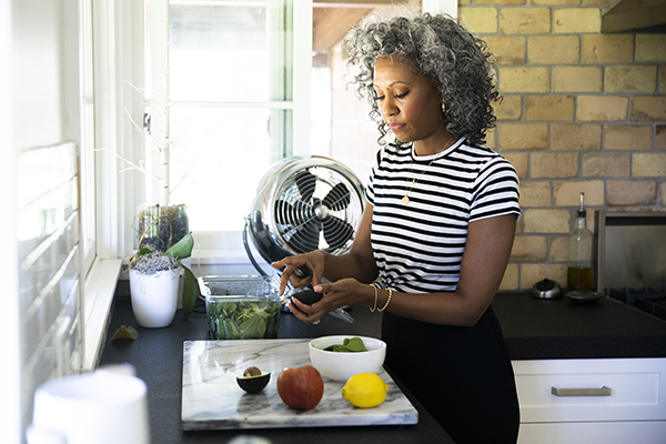 Woman in her kitchen preparing a salad