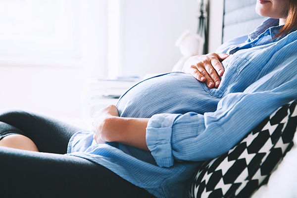 Pregnant woman relaxing in bed