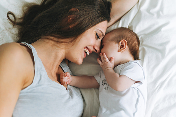 Mom and newborn on bed