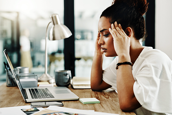 Stressed woman at her home computer