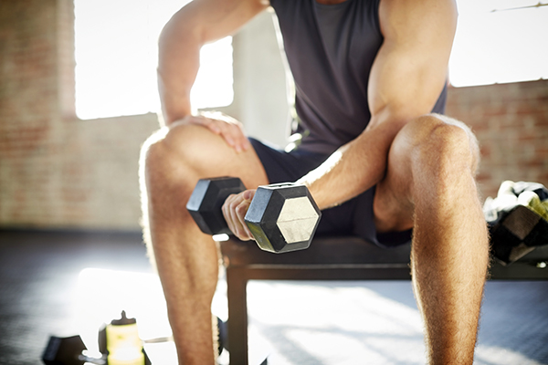 Man doing biceps curl with dumbbell