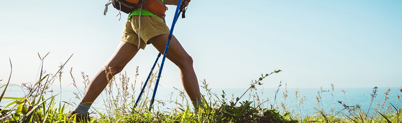 Woman hiking on seaside mountain trail