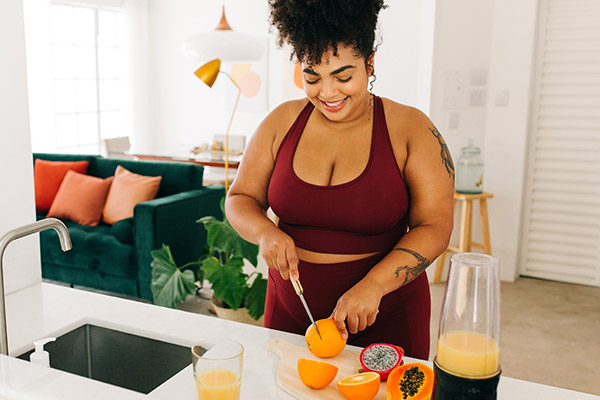 Woman making smoothie at home