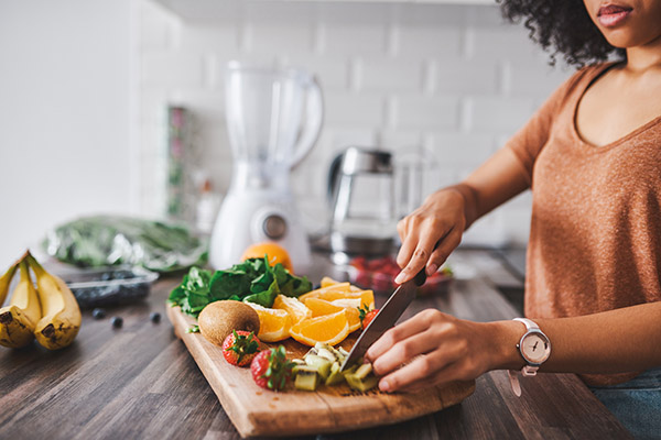 Woman cutting fruit on a cutting board