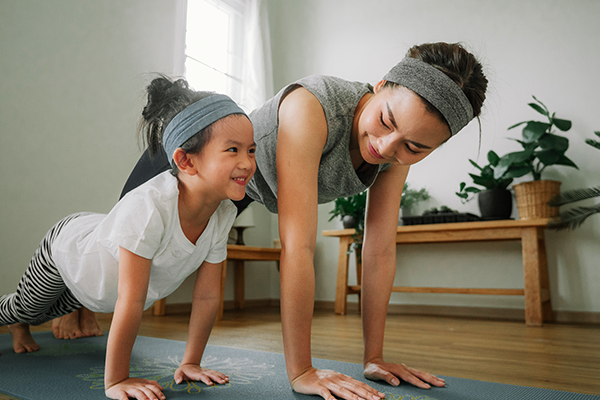 Woman exercising with her daughter
