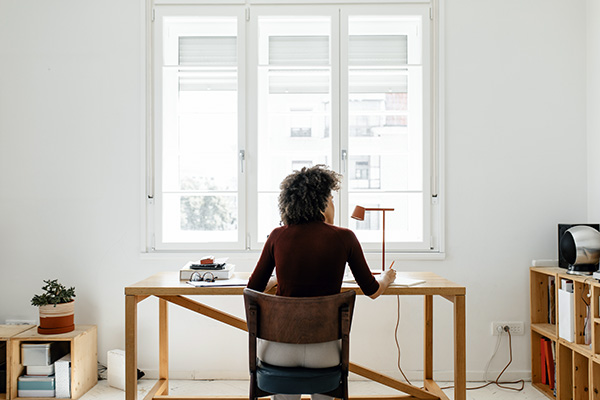 Woman working at desk near window