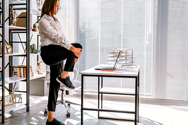 Woman taking stretch break working from home