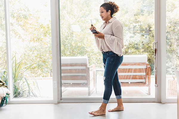 Woman pacing at home on phone