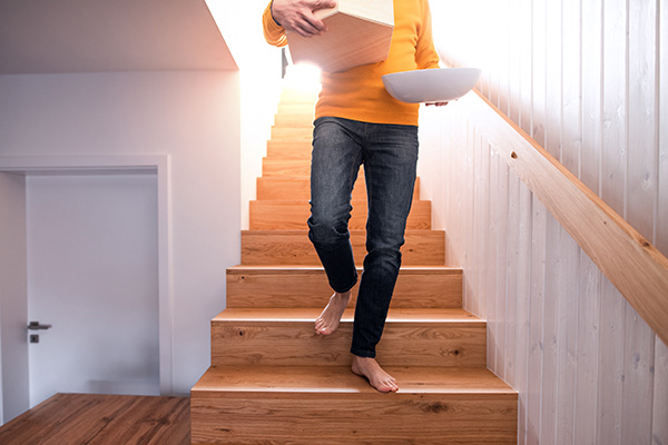 Man walking down stairs at home