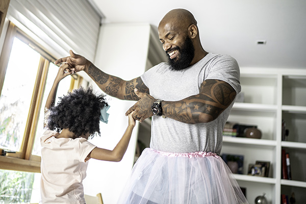 Dad dancing with daughter at home