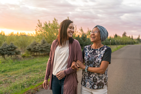 Mother and daughter walking outside