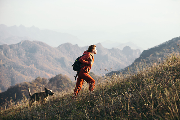 Woman hiking with dog