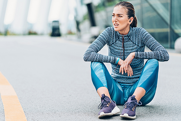 Woman sitting on ground after bad workout