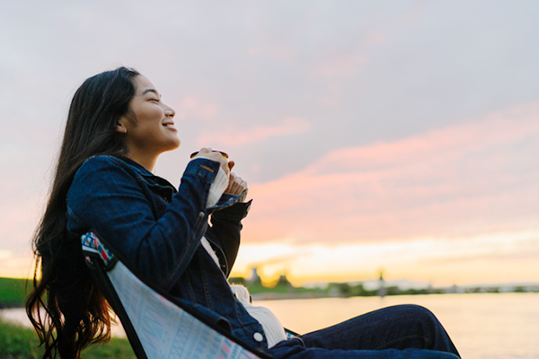 Woman relaxing outdoors at sunset