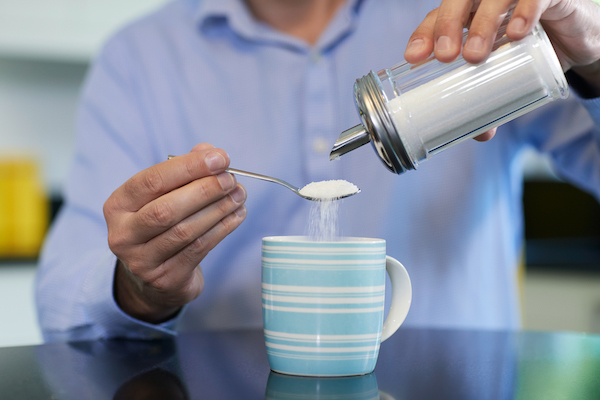 man adding sugar to coffee | other names for sugar