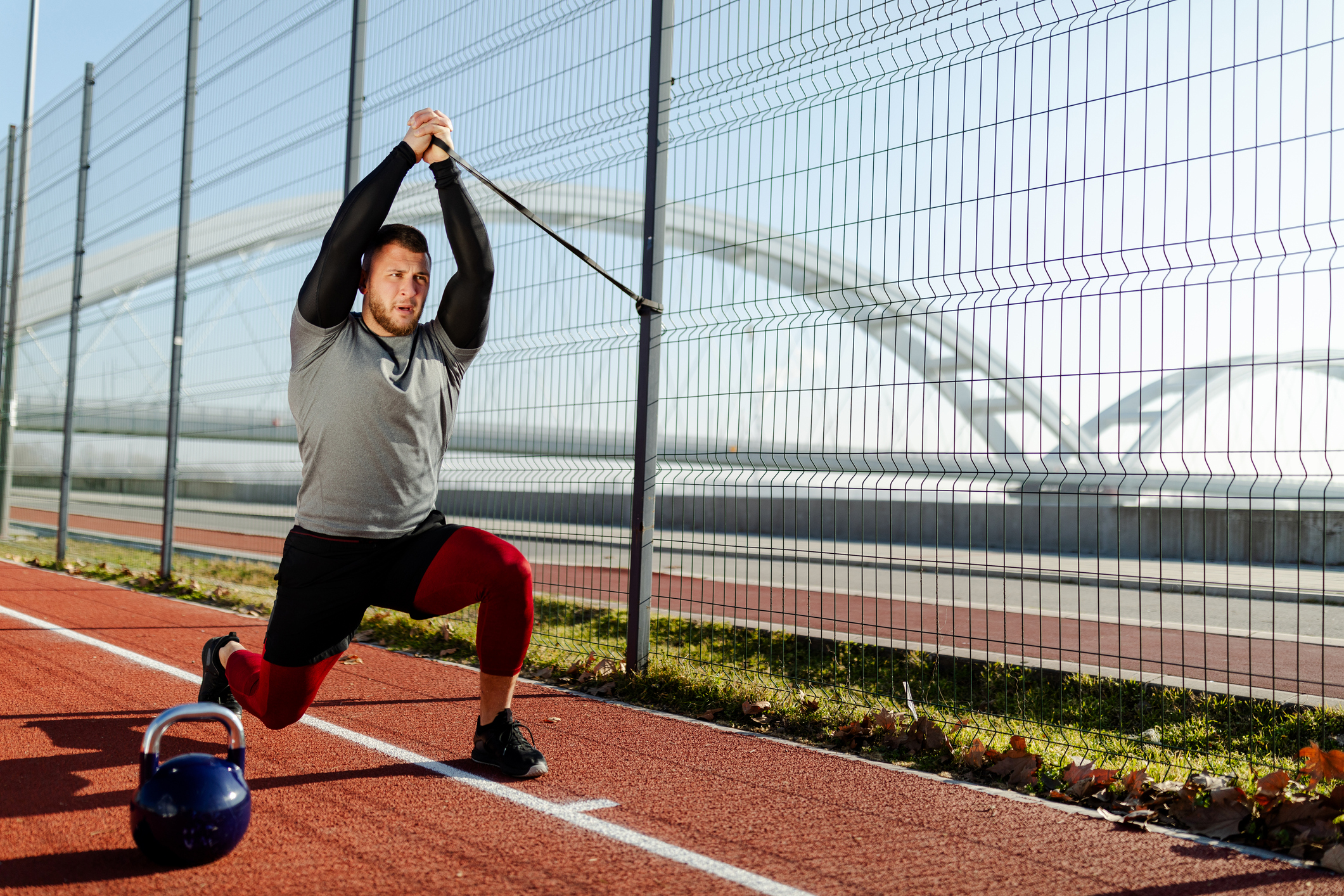 Man Exercising Outside on a Track | Pallof Press