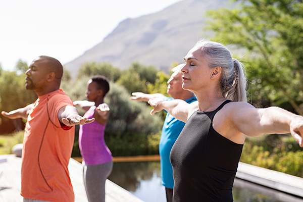 Group of adults doing yoga outside