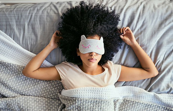 sleeping woman eye mask bed