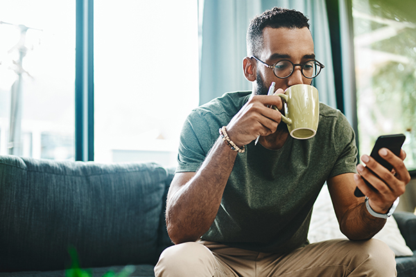 Man drinking coffee at home