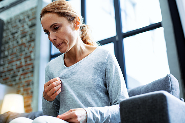 Older woman at home sweating