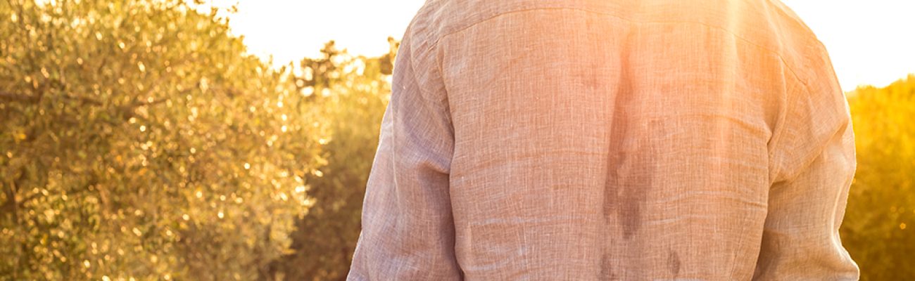 Man outside in sweaty shirt