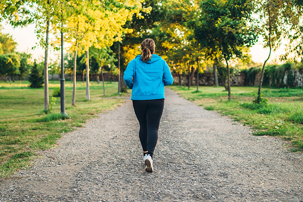 Woman walking outside on path