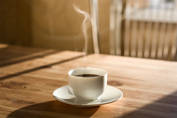 steaming cup of coffee on table | Does Coffee Have Carbs