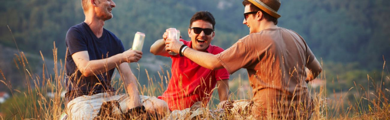 men toasting cans outdoors | white claw