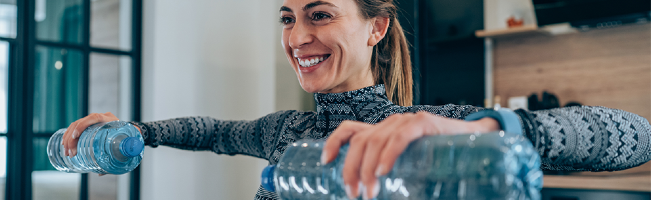 woman using water bottles as weights | Homemade Weights