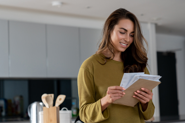 woman checking mail kitchen | holiday fitness