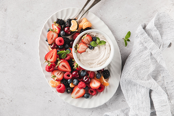 Cookies & Creamy Fruit Dip on a plate of fruit, top view