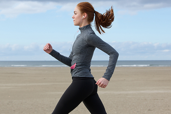 woman running beach | healthy new years resolutions