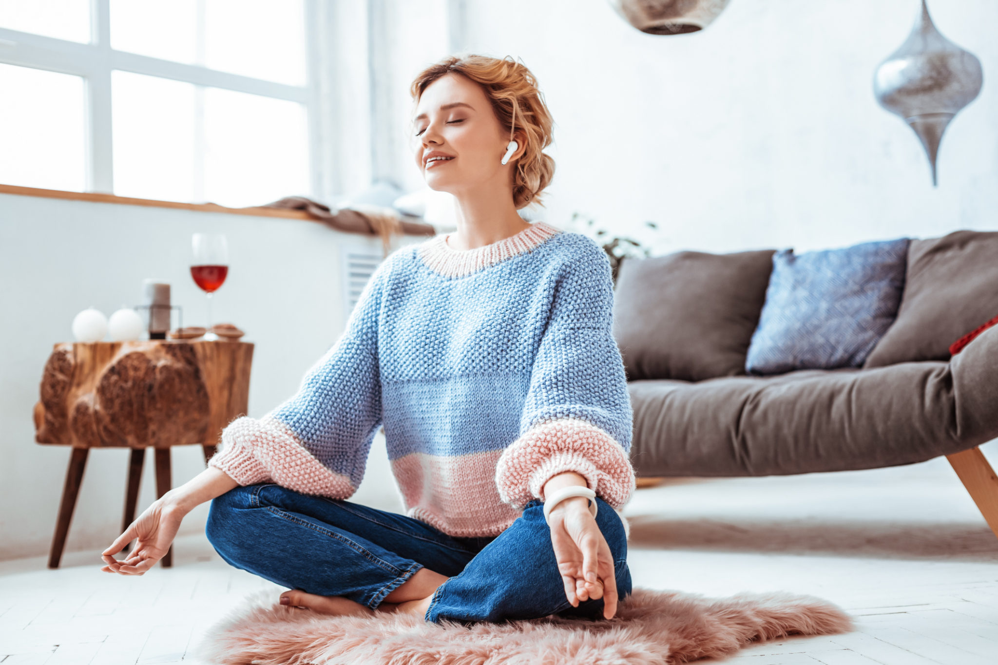woman meditating living room home wine | healthy new years resolutions