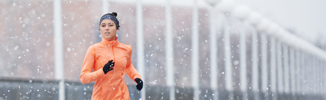 woman running in snowy weather | Find Time to Work Out