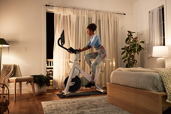 Woman on BODi Bike at home