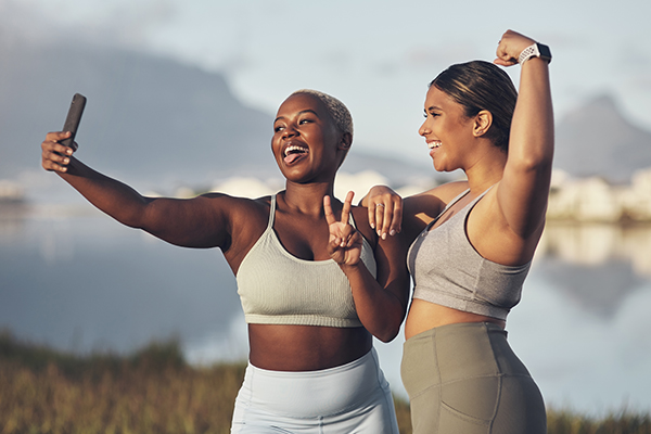 Two athletic women taking selfie outside